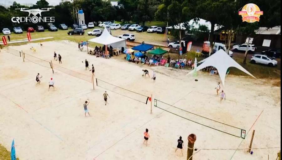 Jogadores competindo no torneio de beach tennis em Imara, destacando a energia e a camaradagem do evento.