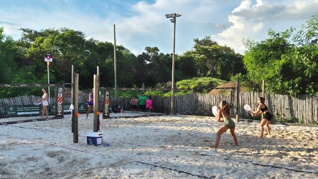 Jogadores de beach tennis competindo no MS Open em uma quadra de areia.